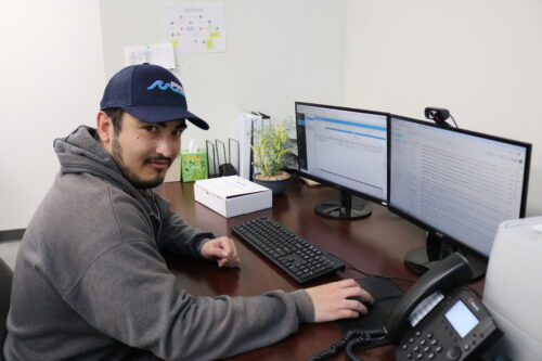 pme team member on computer in office