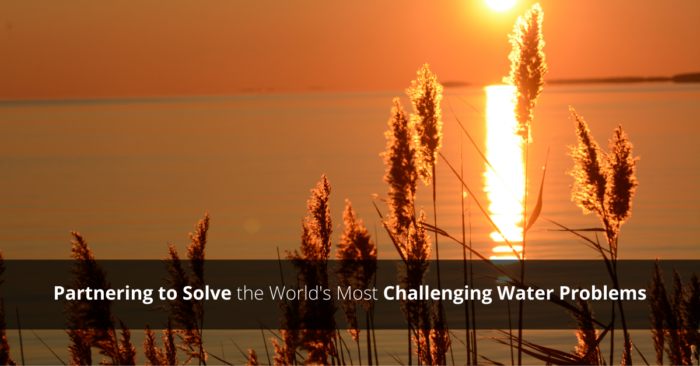 sun over the water. text on image: partnering to solve the world's most challenging water problems