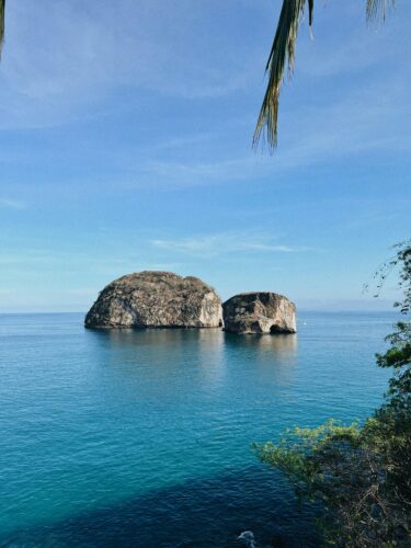 Image of Mismaloya Arches in Mexico surround by a body of open ocean.