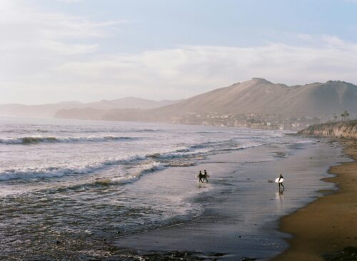 surfers coastal beach